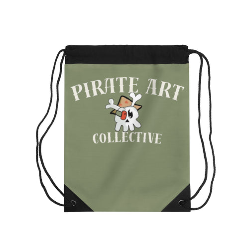 An olive green drawstring backpack with black cords and black corner accents, featuring a white cartoon skull character wearing a brown hat and the text 'PIRATE ART COLLECTIVE' in white.